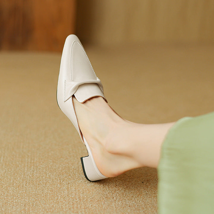 Pair of elegant brown leather mules for women, designed with a fashionable bow accent