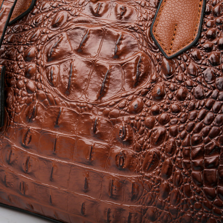 Detailed shot of the faux leather croc-embossed women's handbag, emphasizing its quality