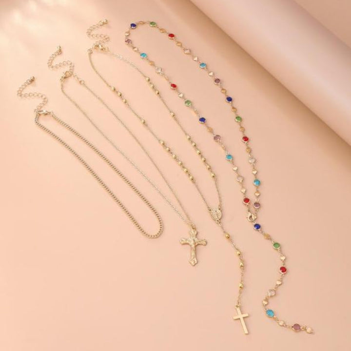 Women's shimmering silver-tone cross pendant layered necklace, adorned with delicate crystal accents.
