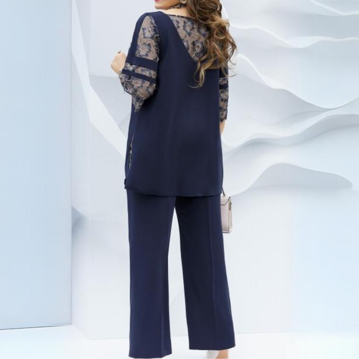 Fashionable women's dark blue two-piece outfit, including a flowing blouse & sleek trousers. An elegant summer style.