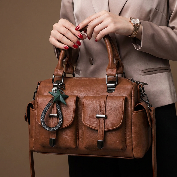 Women's sleek red faux leather shoulder bag with a stylish adjustable strap, a versatile accessory.