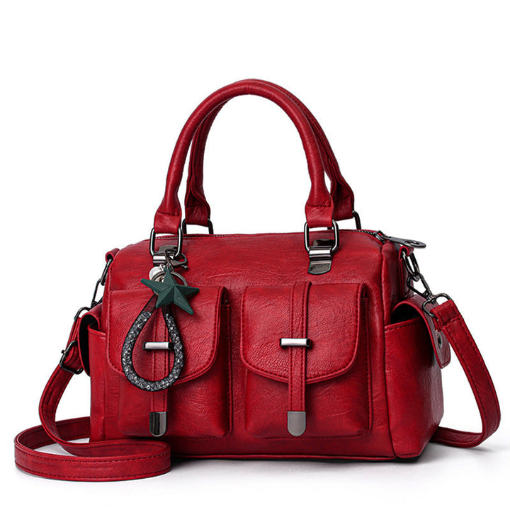 Detailed view of a women's elegant faux leather shoulder bag showcasing its texture and design.