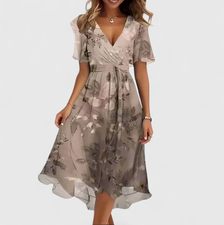 Side view of a woman in a stylish floral midi dress with plunge V-neck & flutter sleeves. Special occasion wear.