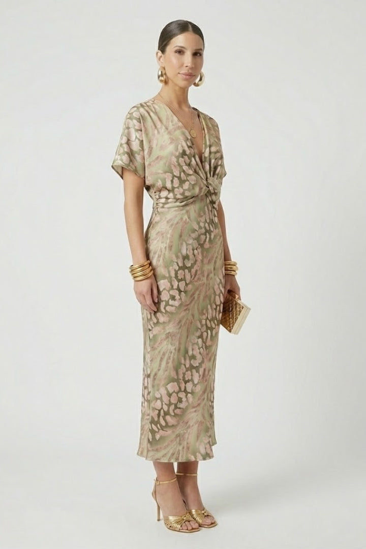 Beautiful women's green floral midi dress featuring a V-neck, short sleeves, and elegant pleated skirt detail.