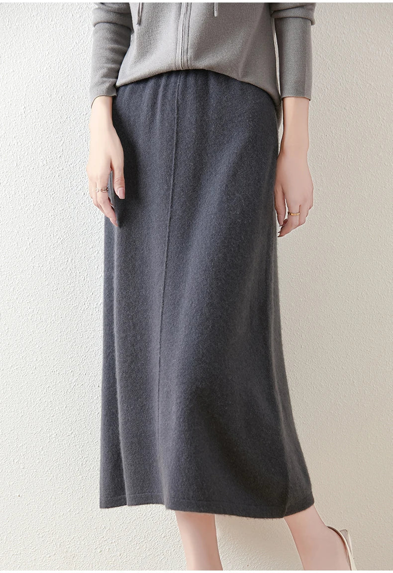 Olive merino wool knit maxi skirt against a neutral background, highlighting its rich color and texture.