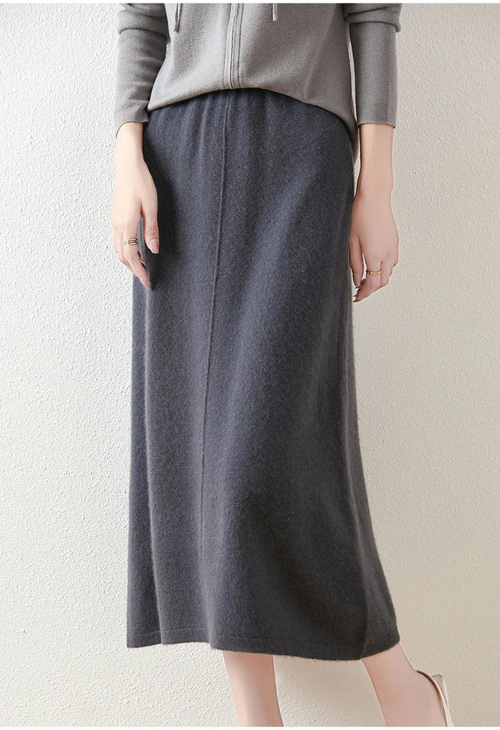 Olive merino wool knit maxi skirt against a neutral background, highlighting its rich color and texture.
