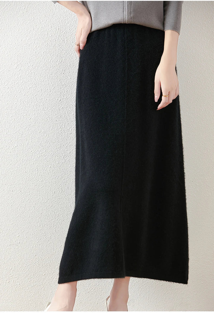 Stylized shot of an olive merino wool knit maxi skirt, emphasizing its elegance and modern design.
