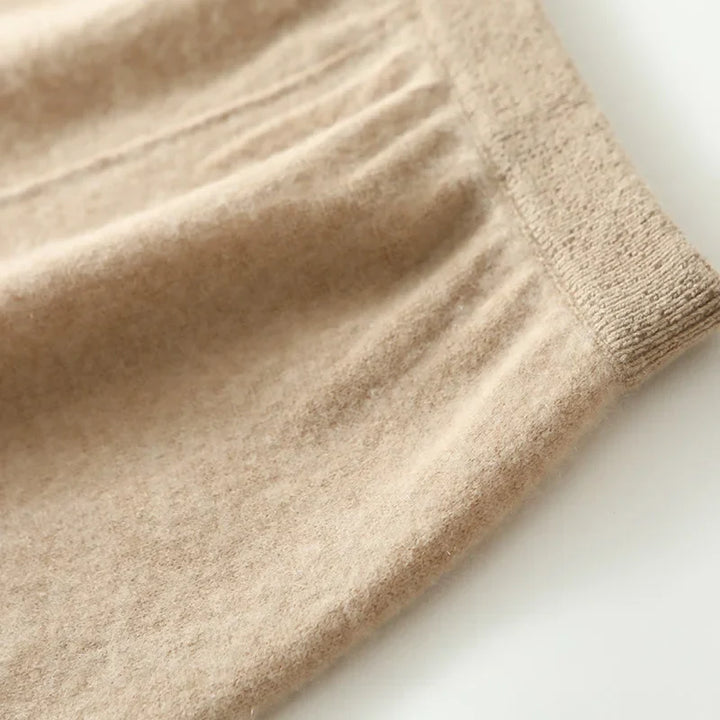 Folded olive merino wool knit maxi skirt, showcasing its compact nature and easy storage.
