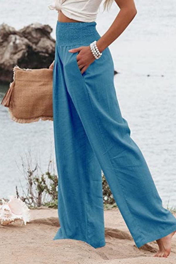Chic women's flowy palazzo pants with a high waist and wide leg, ideal for elegant summer style.
