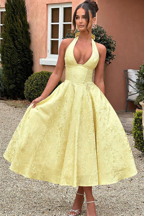 Chic yellow floral midi dress with a halter neck and corset.
