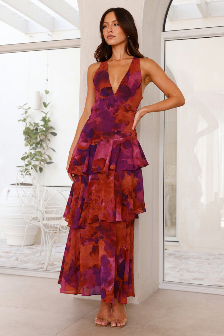 Full-length view of a women's formal V-neck printed maxi dress with a charming tiered ruffle design.