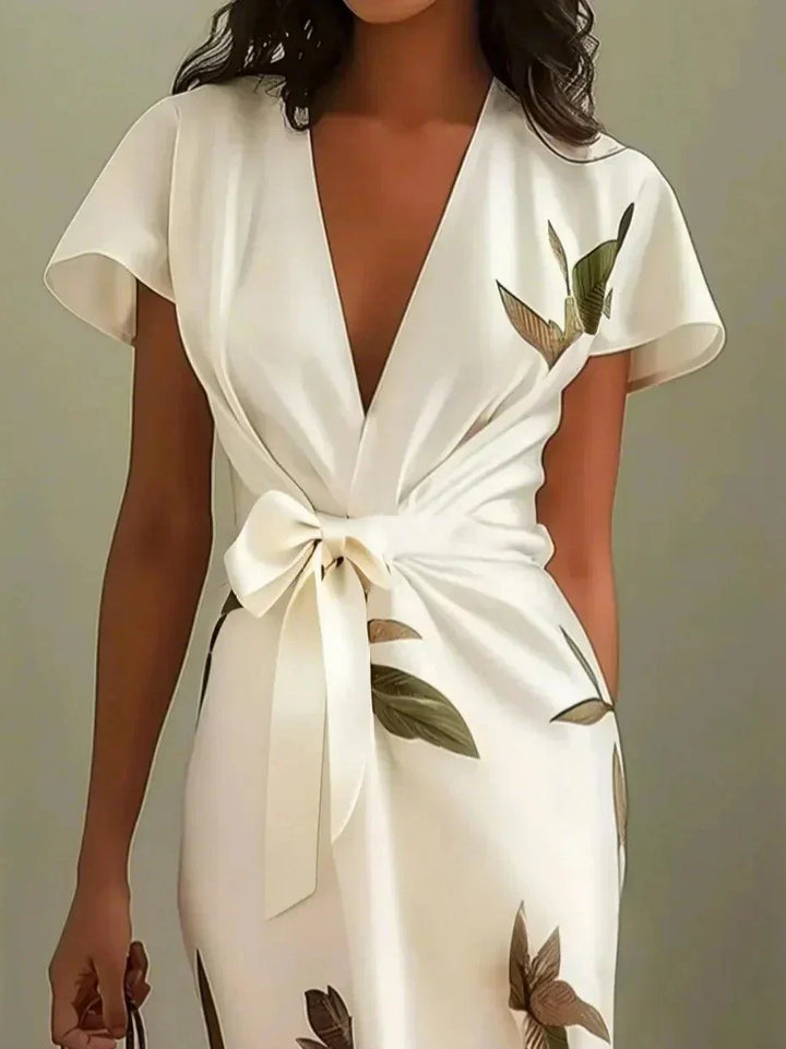 Chic women's V-neck printed wrap dress with short sleeves and flattering tie waist detail.