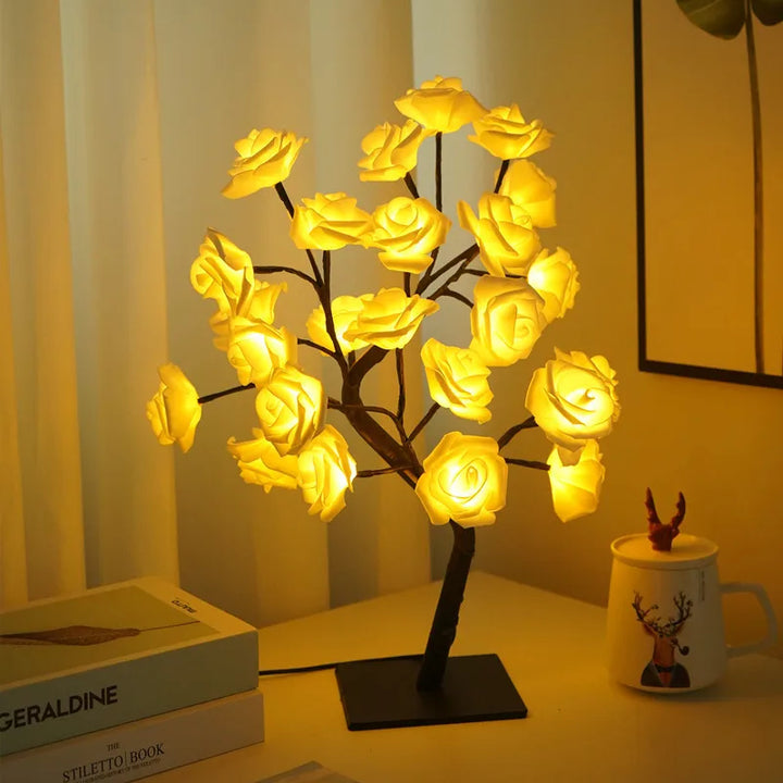 Close-up of a glowing rose LED table lamp, casting a warm ambiance. Ideal for bedroom or living room decor.