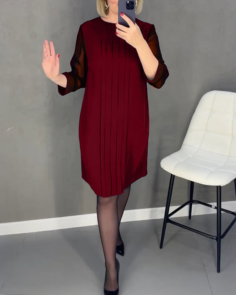 Women's cocktail shift dress, knee-length, featuring stylish mesh panels & long sleeves, perfect for elegant events.