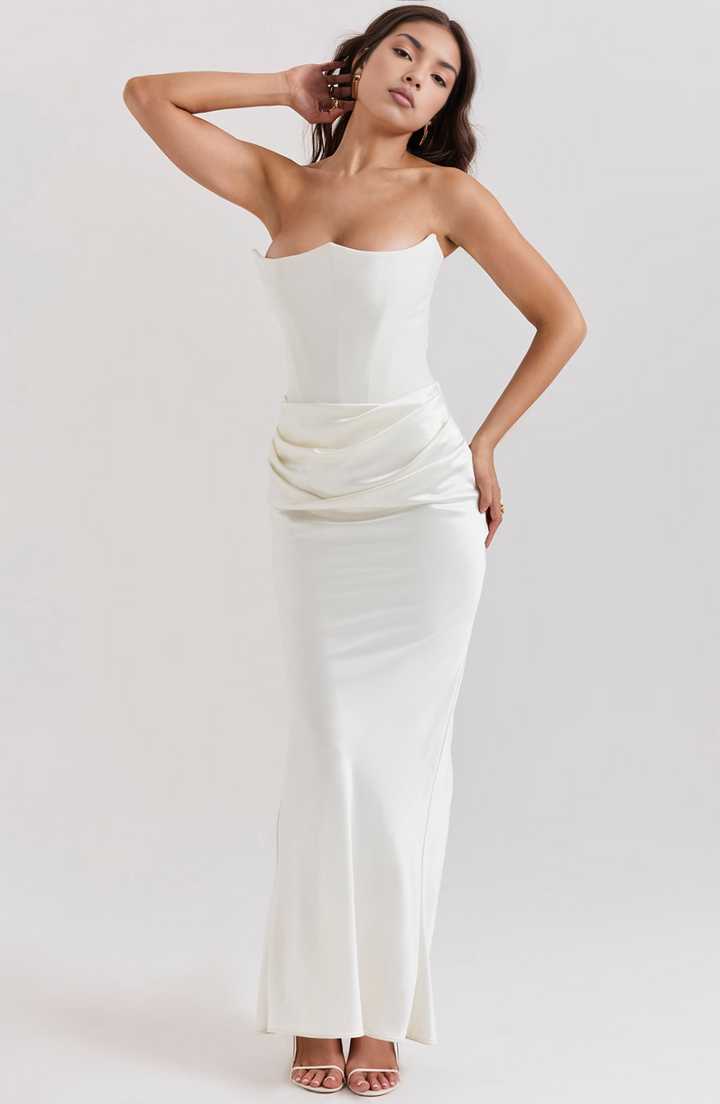 Model wearing a stunning strapless corset maxi wedding guest dress, ready for any gala.