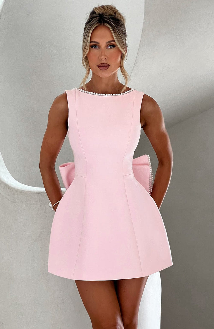 Elegant structured pink mini dress for women, ideal for a wedding guest or cocktail event.