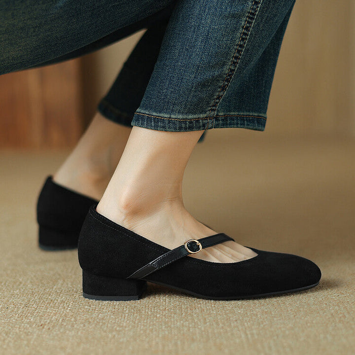 Black suede block heel pumps, ideal women's dress shoes with a unique buckle strap design.