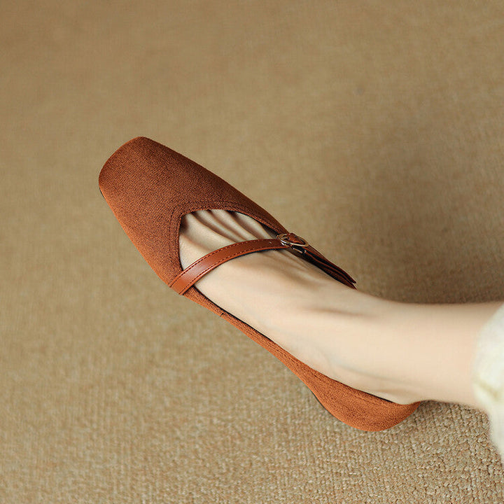 Pair of tan suede block heel pumps with buckle straps, perfect elegant footwear for women.
