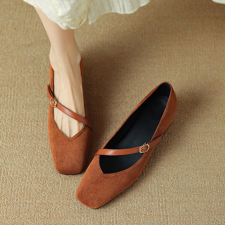 Top view of women's black suede block heel pumps, showcasing a classic design.