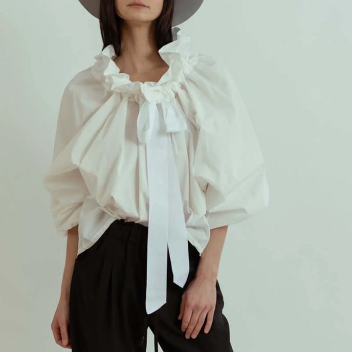 Sophisticated women's blouse in white with elegant puffed lantern sleeves and a charming ruffled neck.