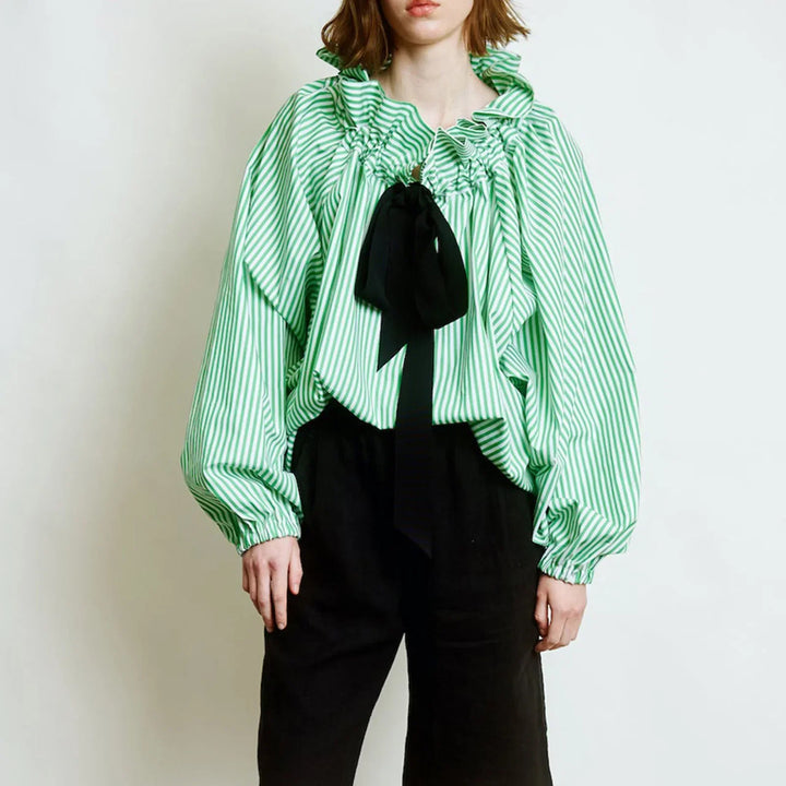 Detail of the puffed lantern sleeve on a white women's blouse, highlighting the elegant design.