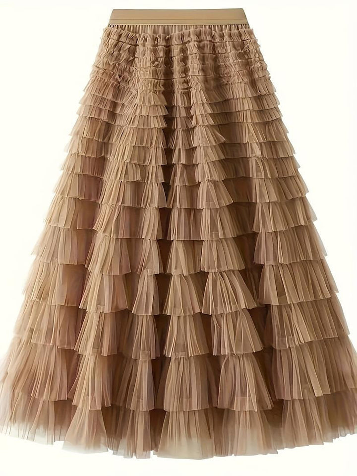 Detail shot of the multiple tiers on an elegant white tulle maxi skirt for women, flowy fashion