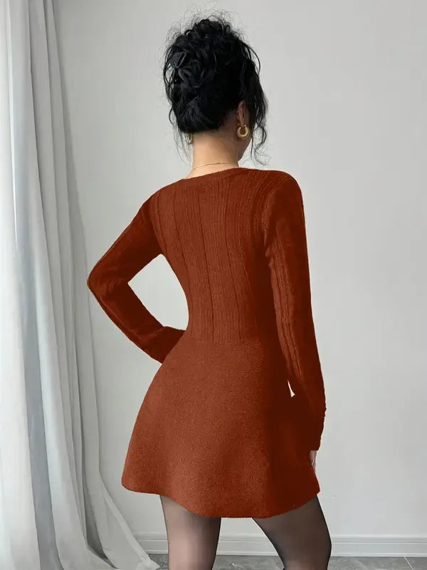 Close-up of a women's V-neck knit mini dress, highlighting the soft viscose blend fabric and flare skirt details.