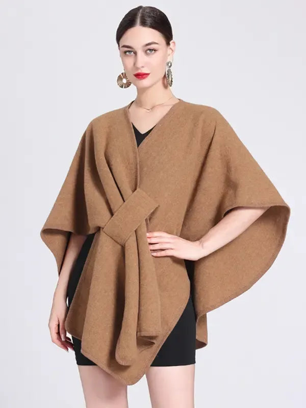 Close-up of a sophisticated women's wrap cape top, highlighting the elegant crepe fabric.