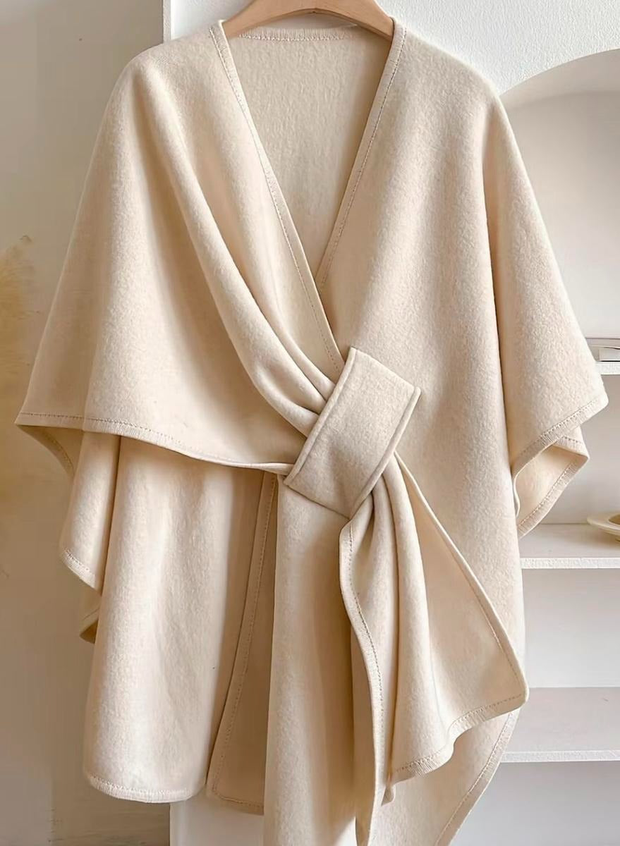 Versatile women's blouse with a fashionable cape and wrap detail, suitable for any occasion.