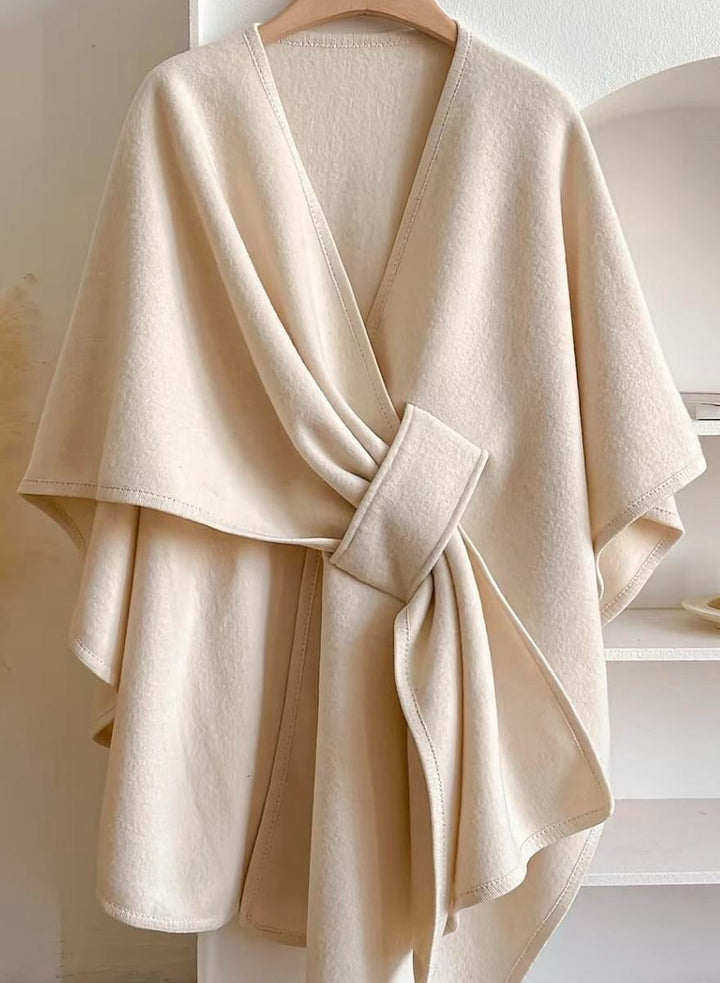 Versatile women's blouse with a fashionable cape and wrap detail, suitable for any occasion.