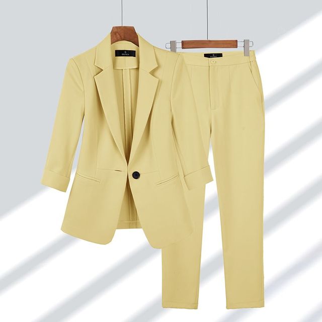Women's elegant blazer & pants professional two-piece outfit. Chic business attire for office and formal occasions.