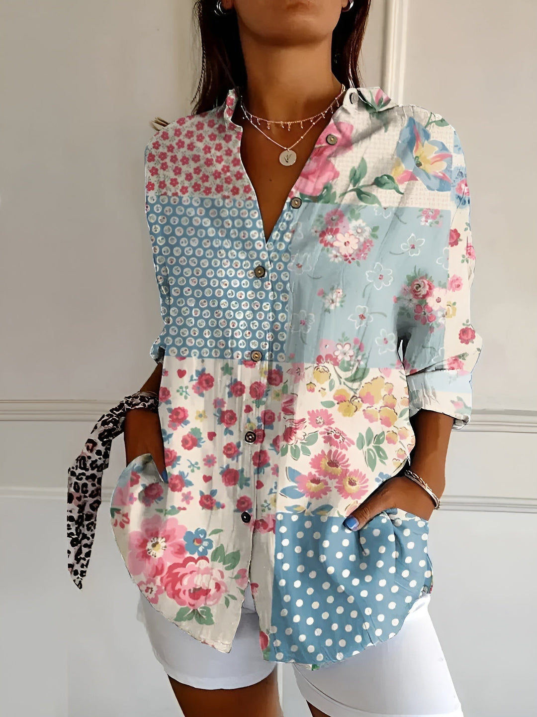 Versatile women's printed top. Elegant button-front collared blouse with three-quarter sleeves & floral design.