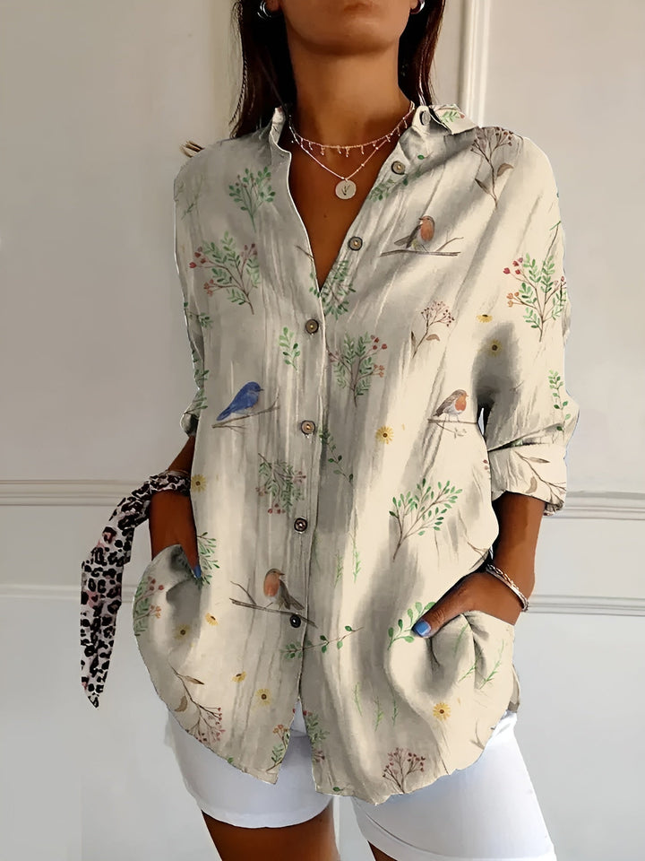 Button-front women's blouse. Elegant collared top with three-quarter sleeves & vibrant mixed floral prints.