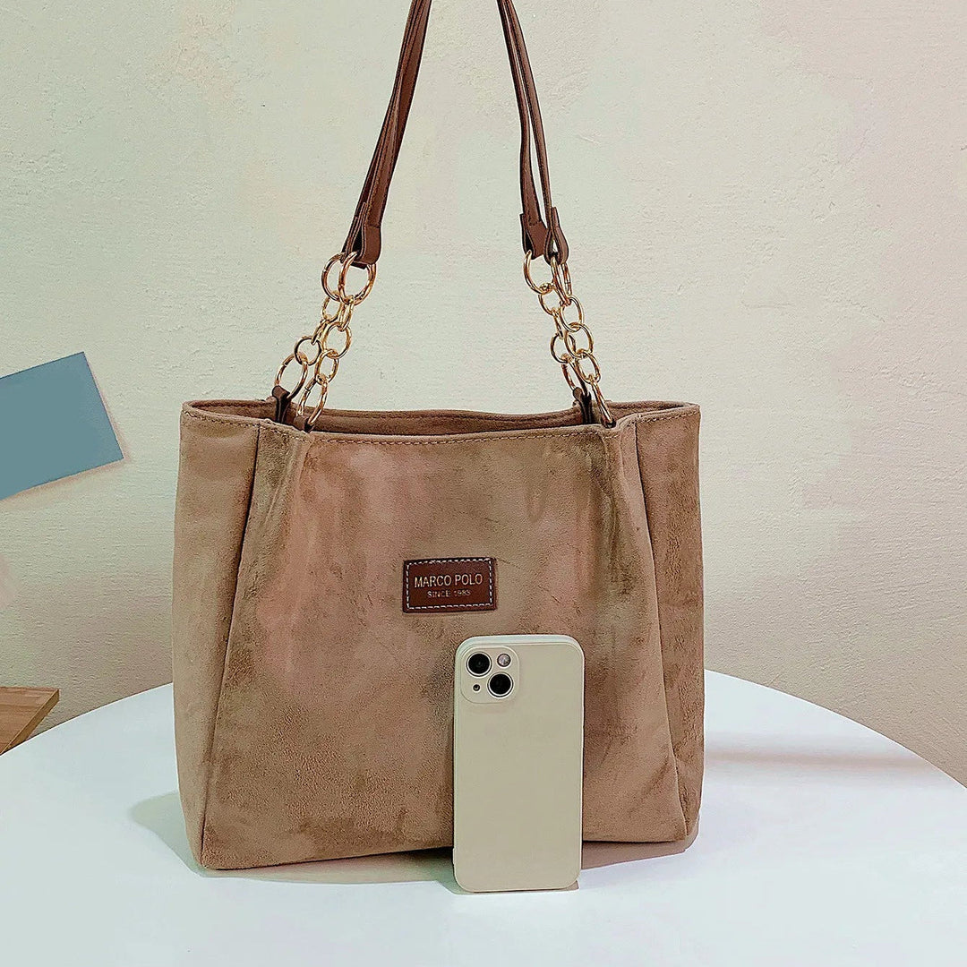 Stylish women's brown suede tote bag, an elegant handbag and travel tote with ample space from a top angle.