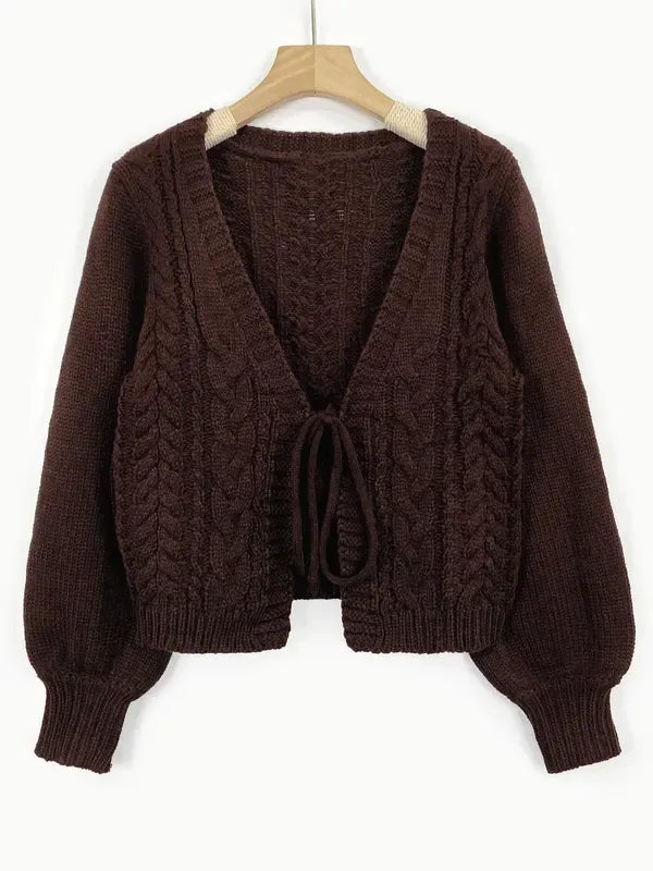 Front view of an elegant women's tie-front cable knit cardigan, ideal for versatile fashion.