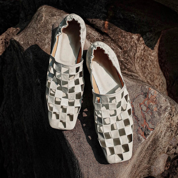 Elegant women's checkered leather mules with slip-on design, perfect for casual or modern outfits.