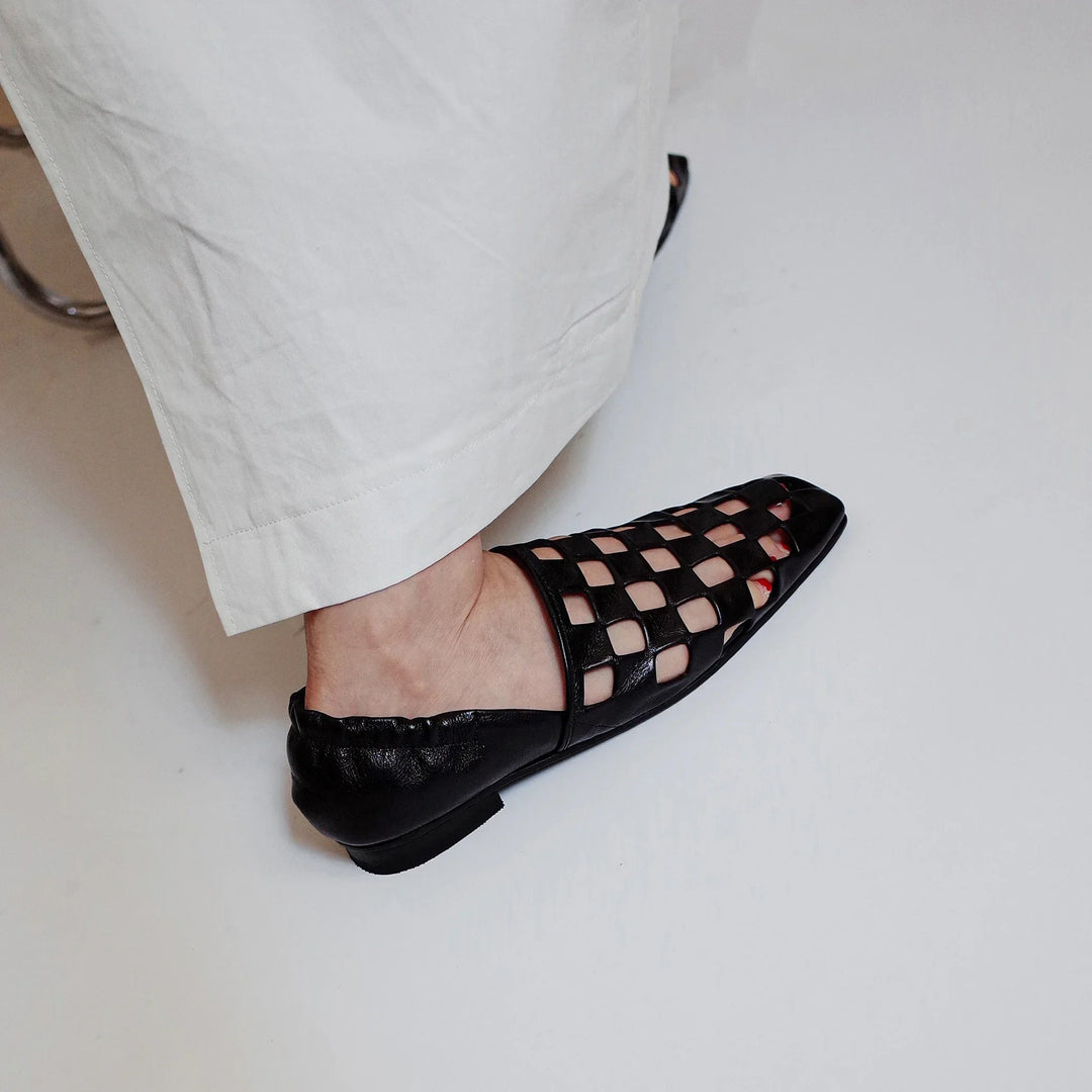 Women's elegant leather mules in a checkered design, offering a stylish and effortless footwear option.