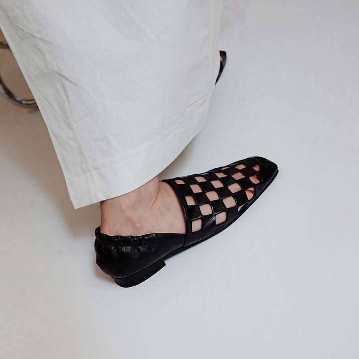 Women's elegant leather mules in a checkered design, offering a stylish and effortless footwear option.