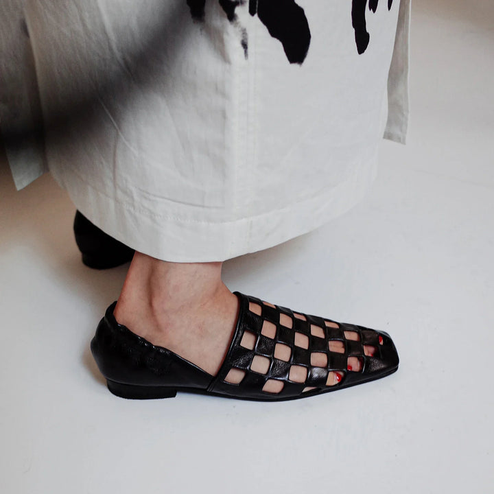Pair of women's casual checkered leather flats, perfect for modern fashion and easy slip-on convenience.