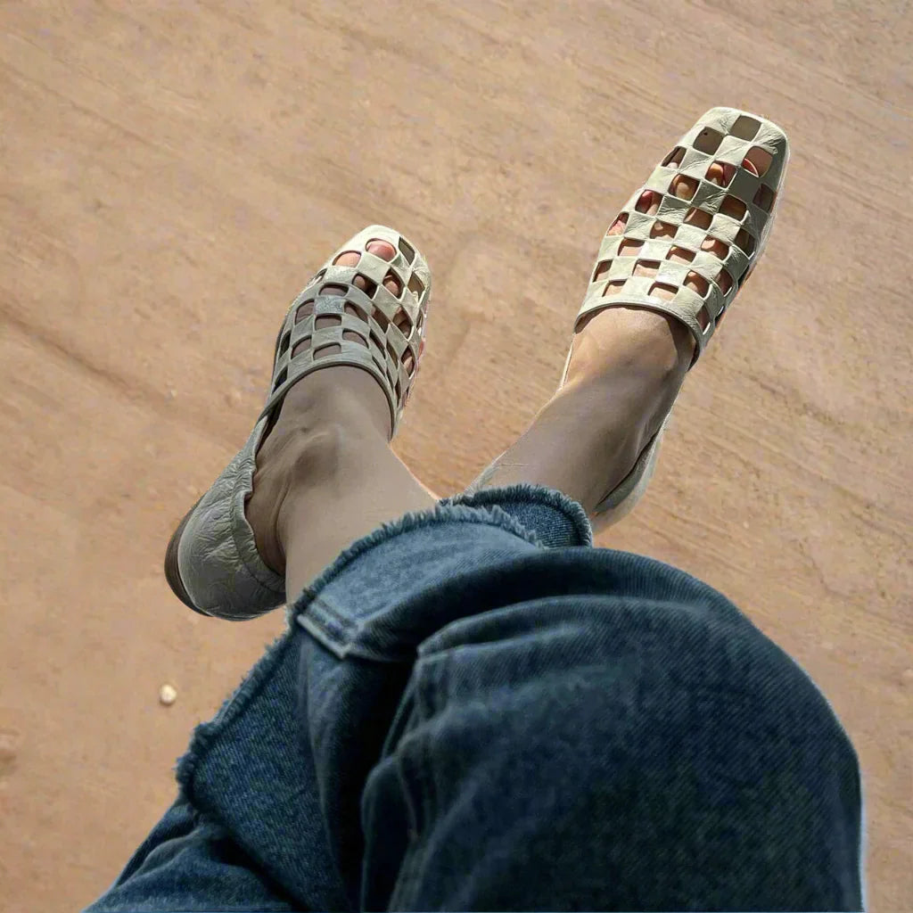 A collection of women's elegant checkered leather mules in various lighting, emphasizing their sophisticated style.