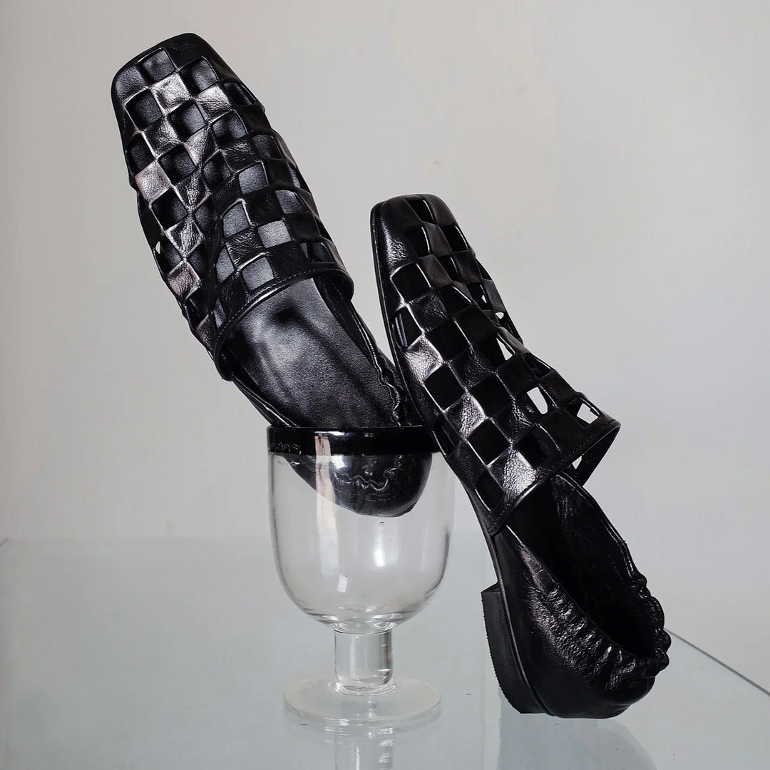 Side view of a pair of women's sophisticated checkered leather slip-on mules, ideal for everyday wear.