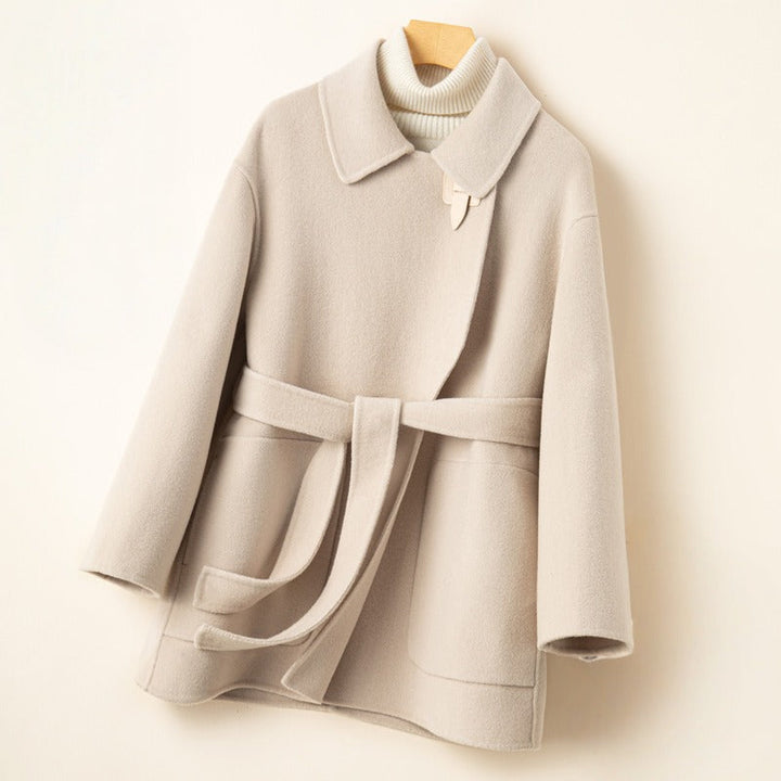 Fashionable women's belted wool blend coat featuring a chic wrap front and cozy winter warmth