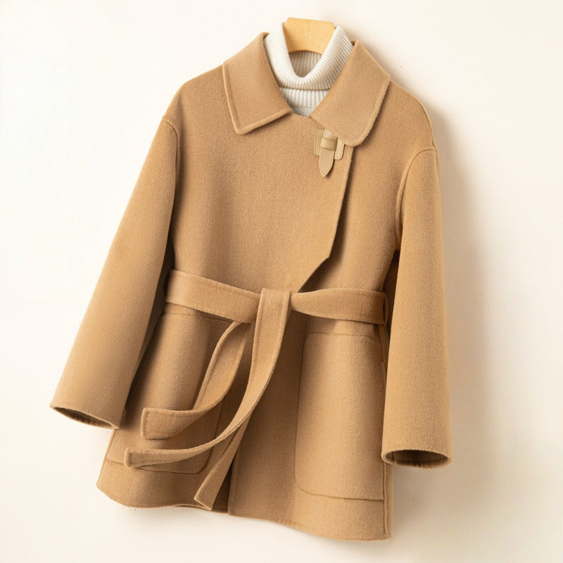 Close-up of a women's elegant wool blend wrap coat with a stylish belt, showcasing quality fabric