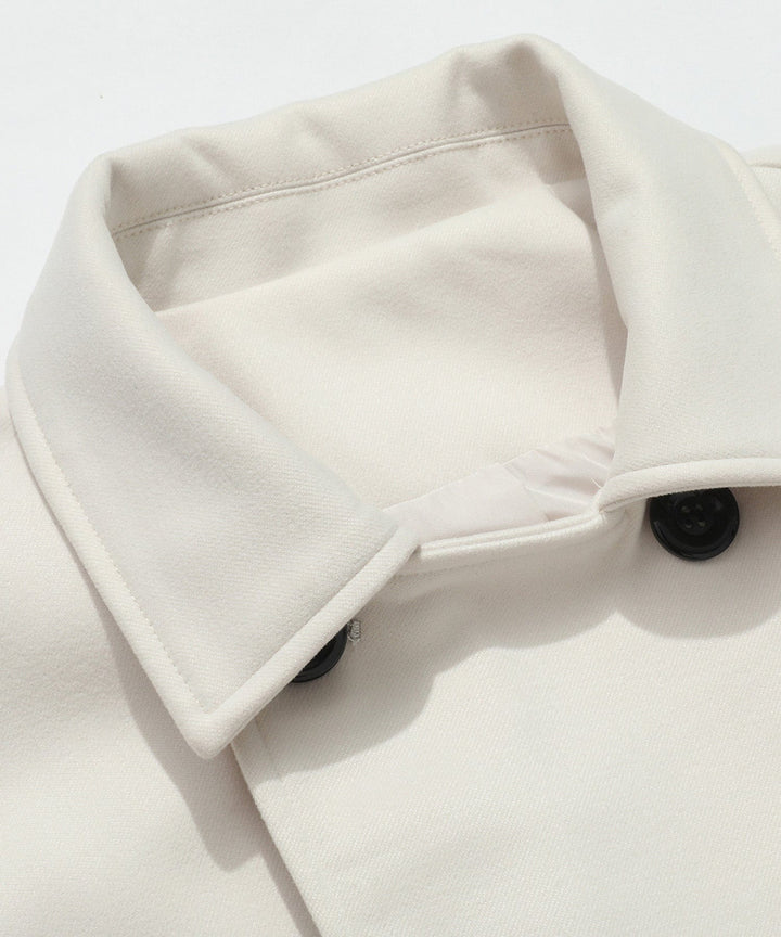 Women's white trench coat, an essential double-breasted outerwear piece for elegant spring and fall fashion.