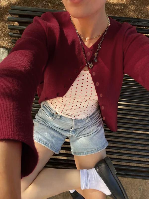 Fashionable women's cropped knitwear, an alpaca blend button-front cardigan in a rich, solid color