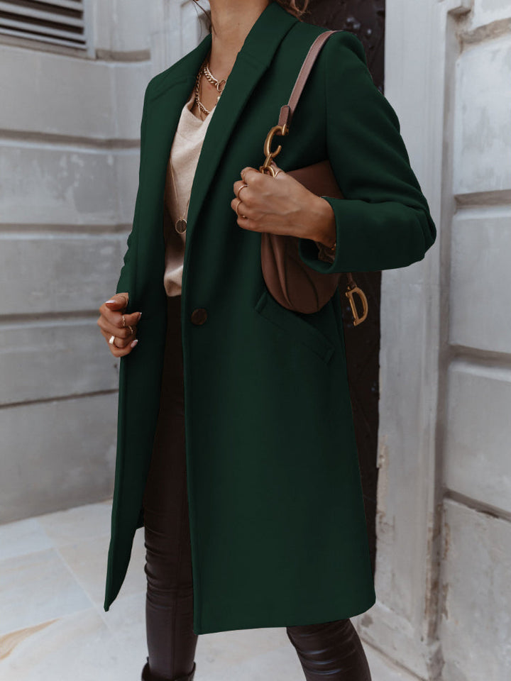 Detail shot of the double-breasted closure on a women's long trench coat, stylish and functional.