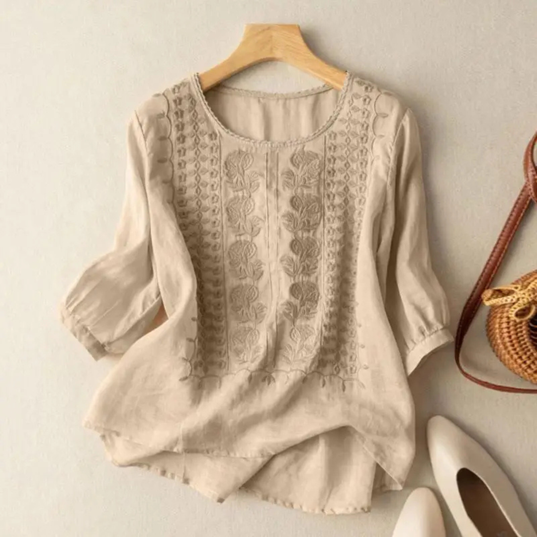 Relaxed fit women's embroidered top with 3/4 sleeves, a versatile piece for elegant summer fashion.
