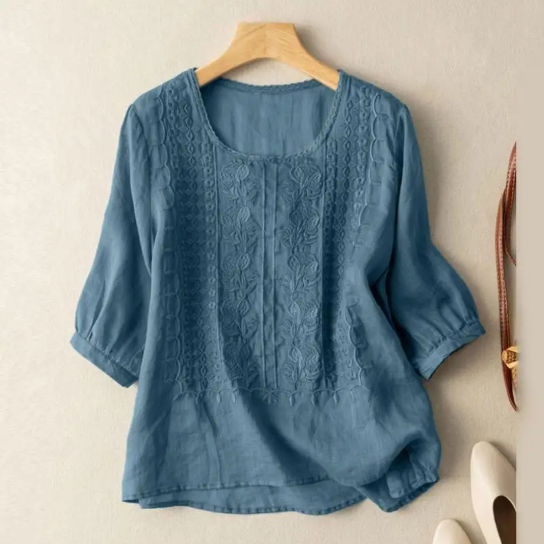 Chic women's blouse featuring intricate embroidery and comfortable 3/4 sleeves, ideal for elegant day wear.