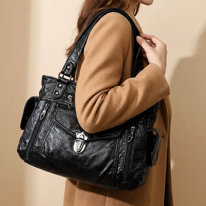 Close-up of elegant faux leather shoulder bag for women, showing texture and stitching.