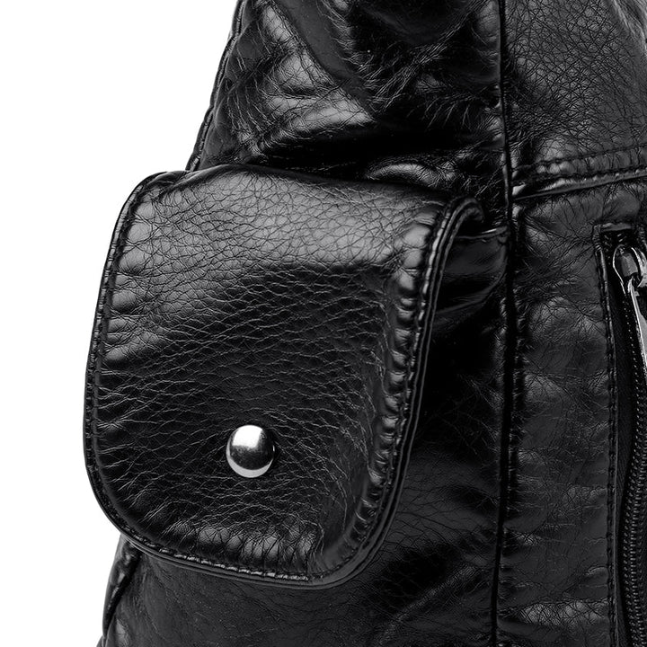 Side profile of elegant women's faux leather handbag, showcasing its structured design.